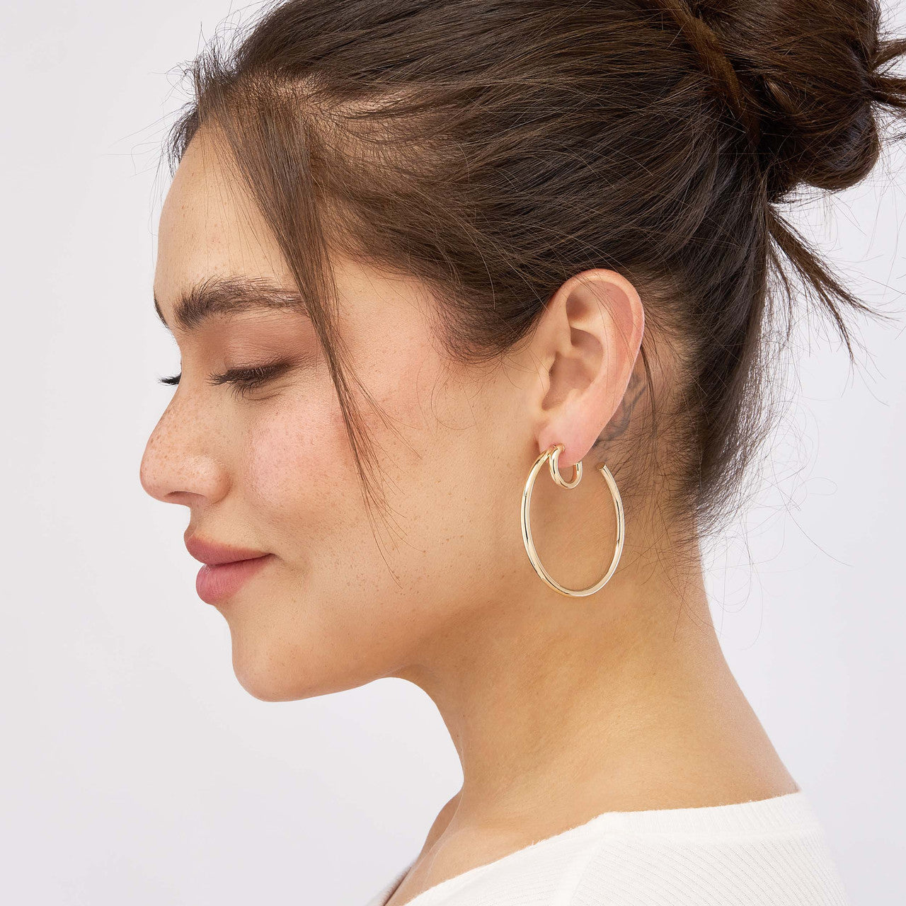 Simple 50mm double hoop earrings in gold by My Store, featuring a sleek and modern design.
